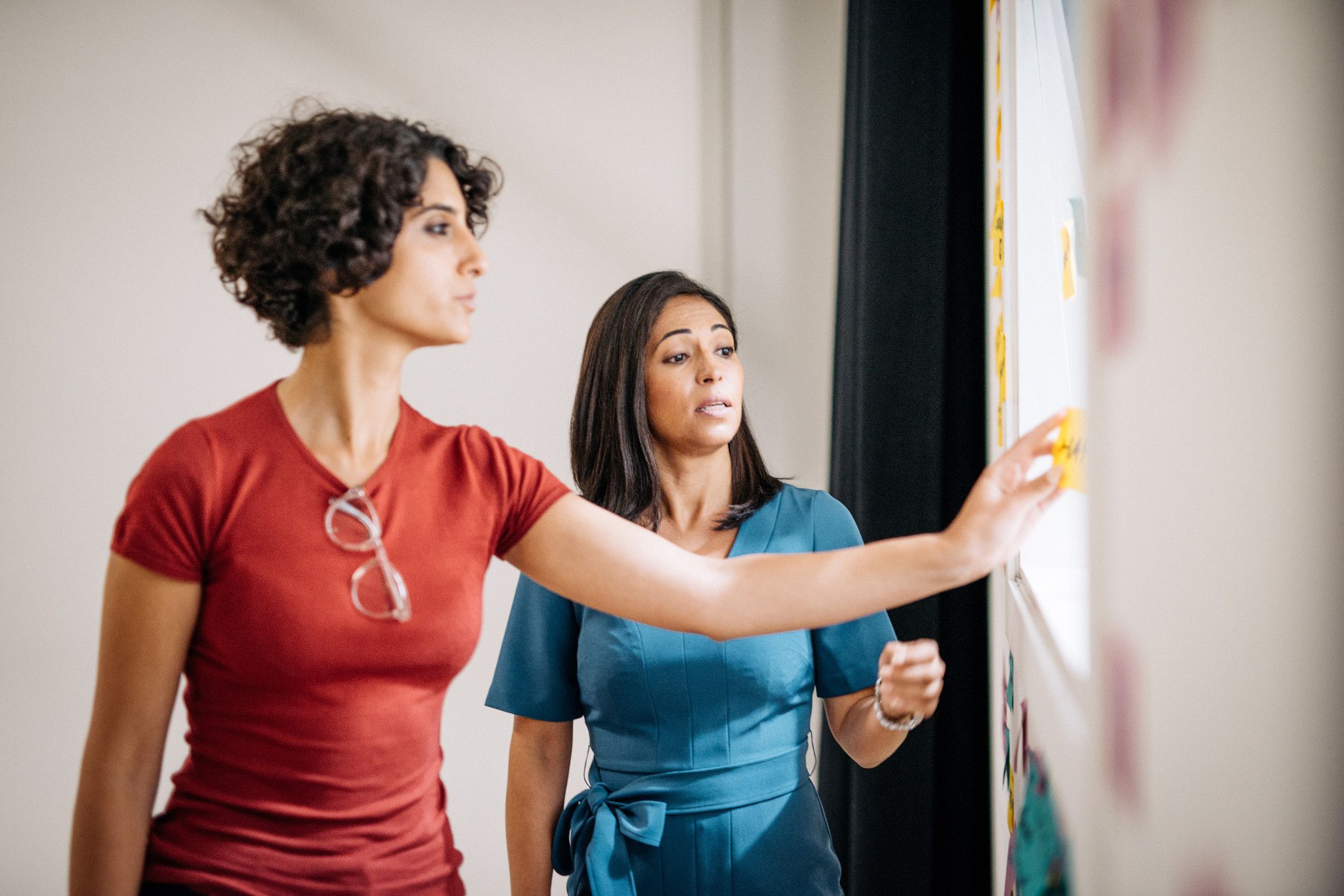 female students working on whiteboard