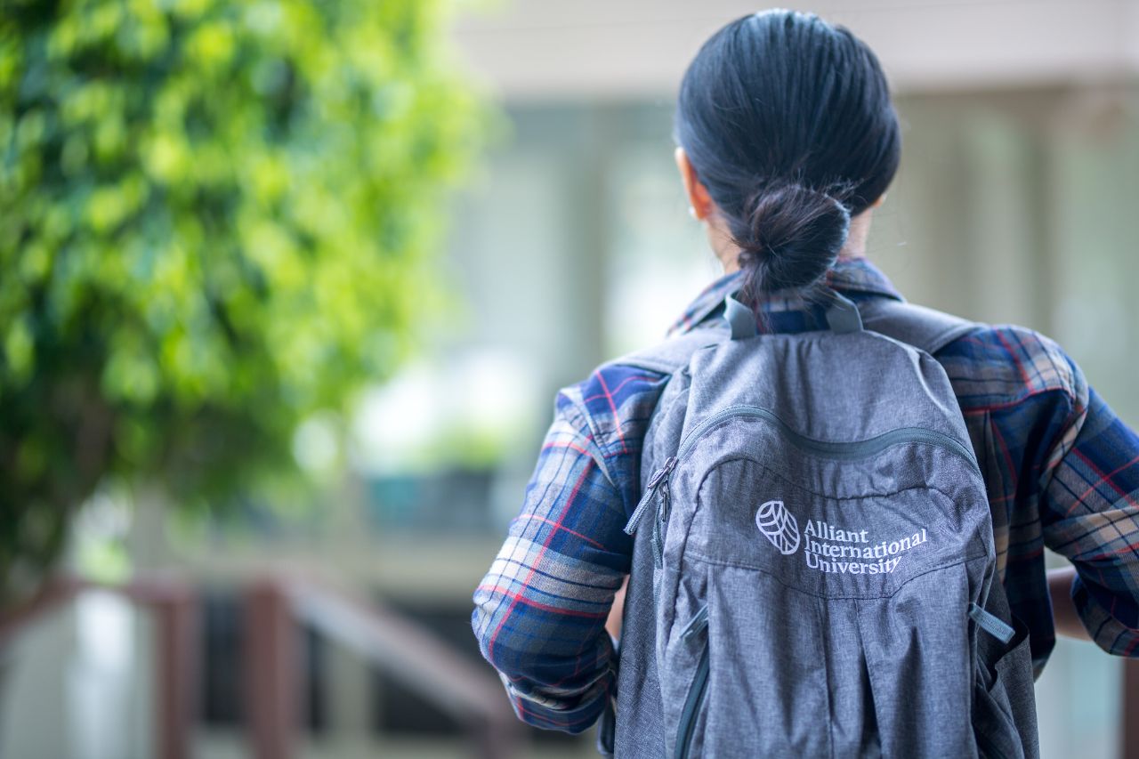 student wearing alliant backpack