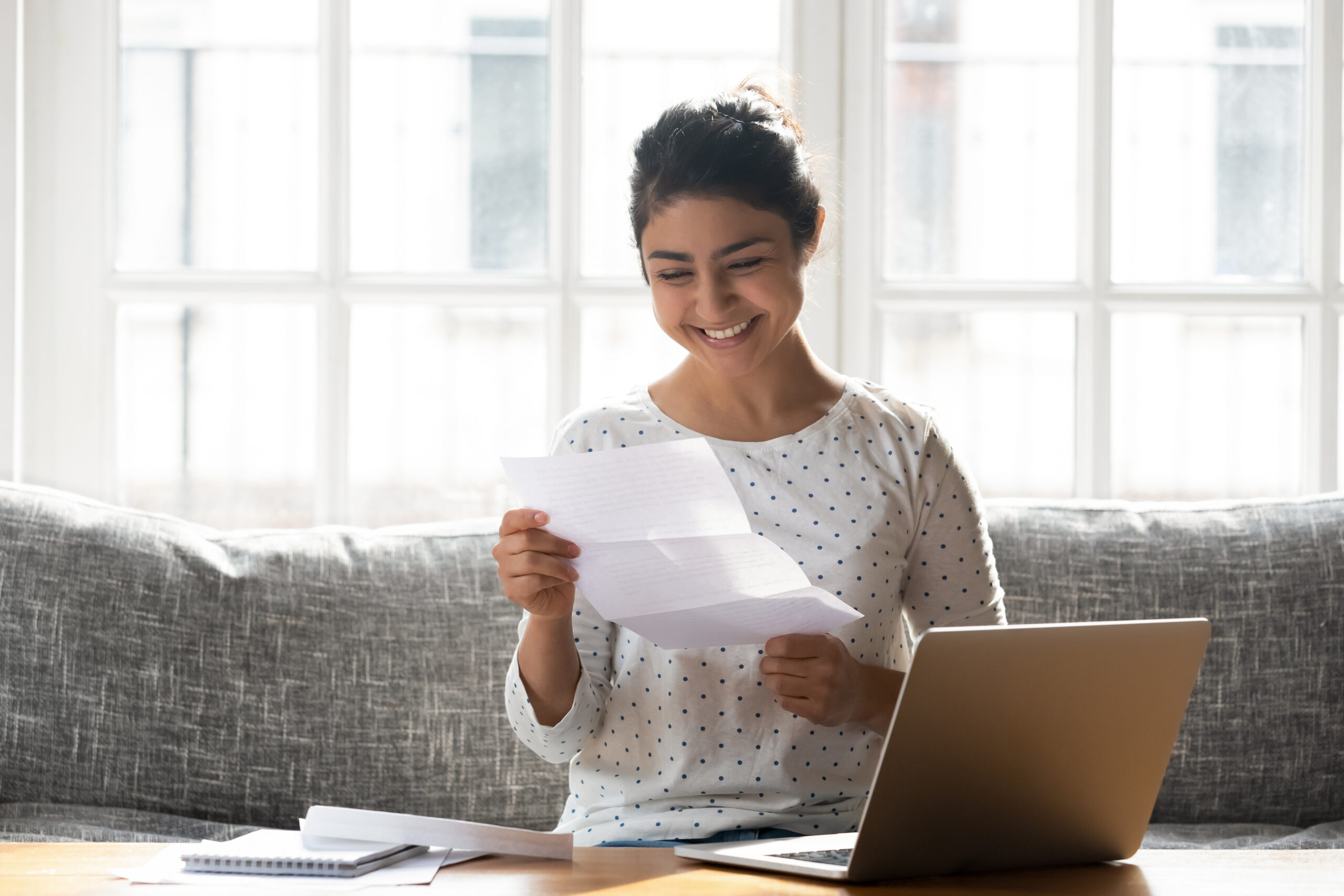 happy woman holding a CSPP psychology scholarship paper