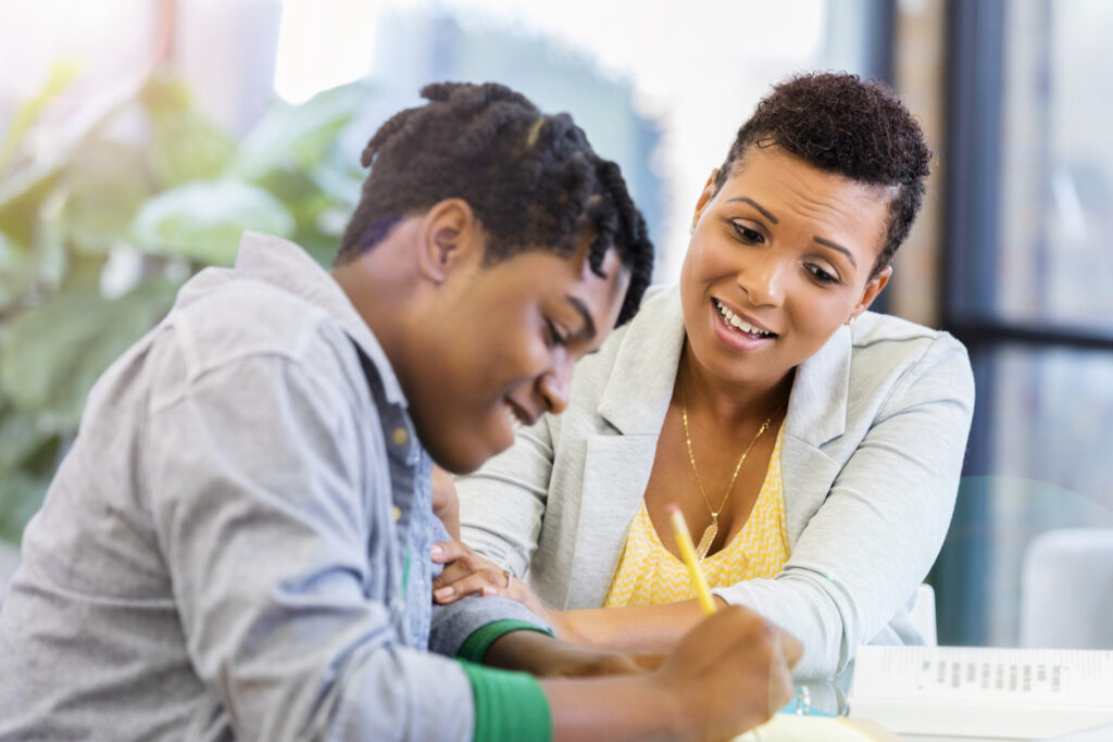 A woman and a boy working on a paper