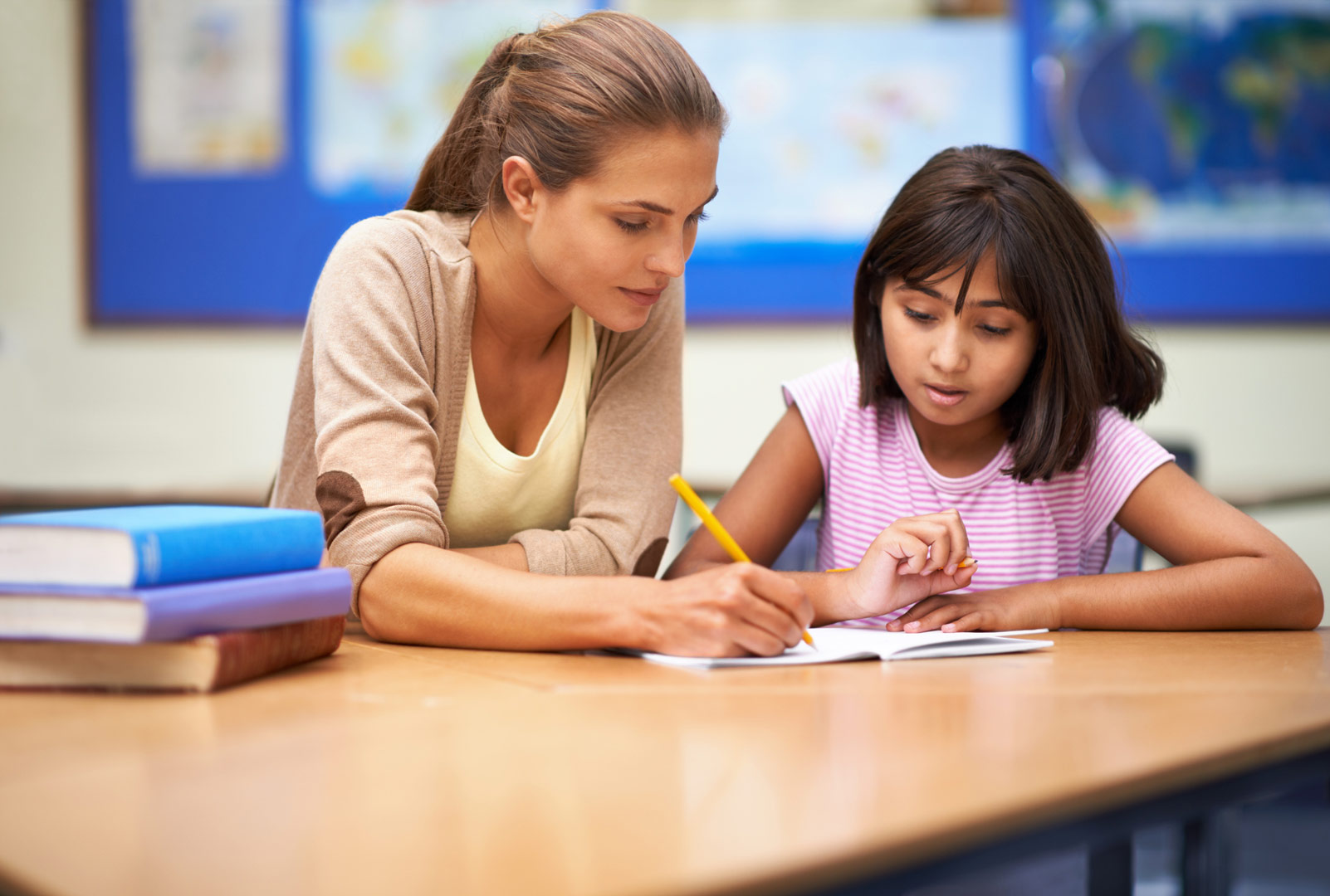 woman helping child student with school work