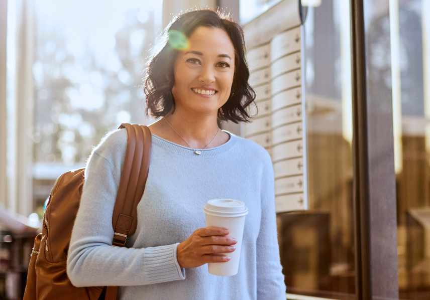 student holding a coffee