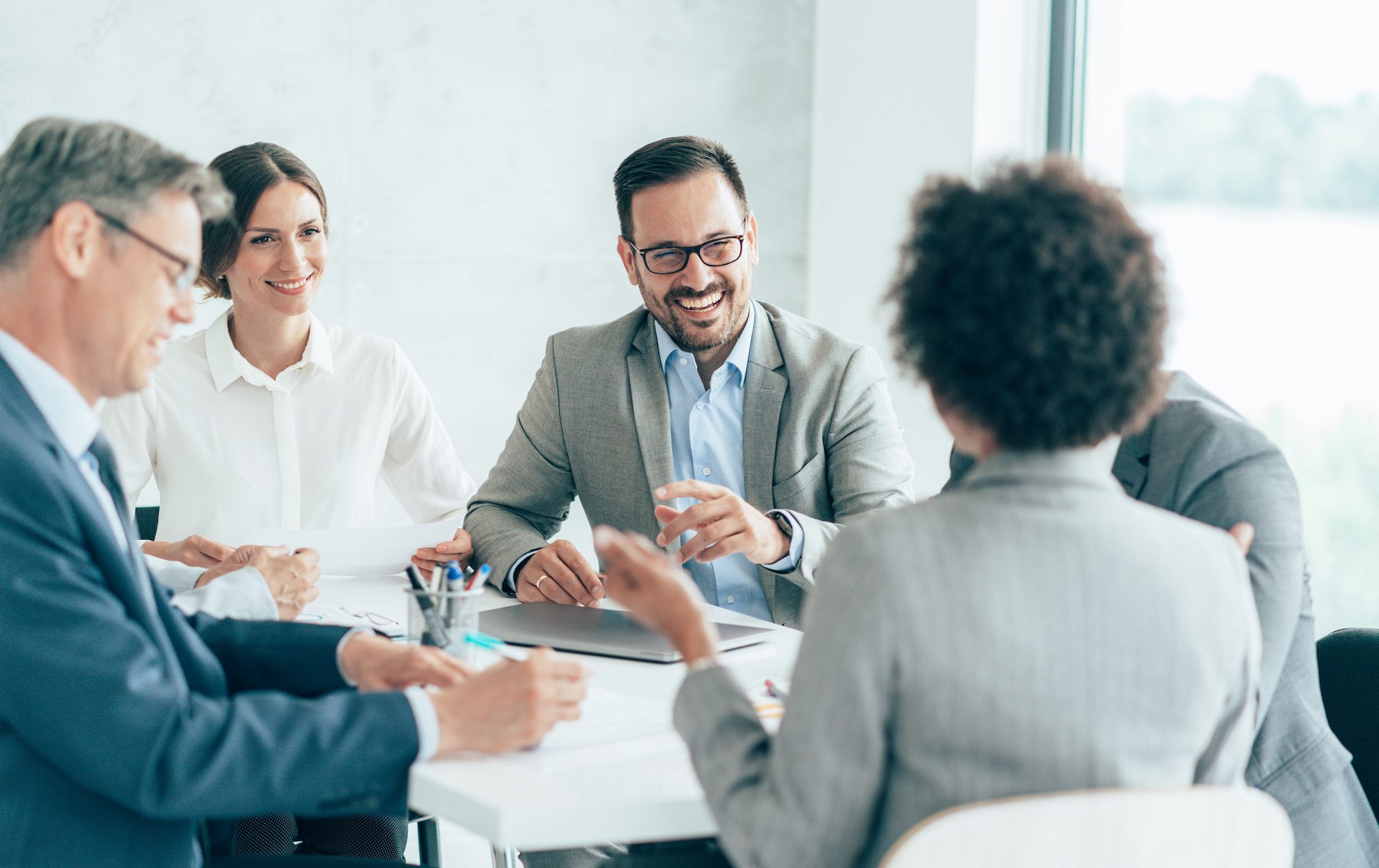 man smiling in a business meeting