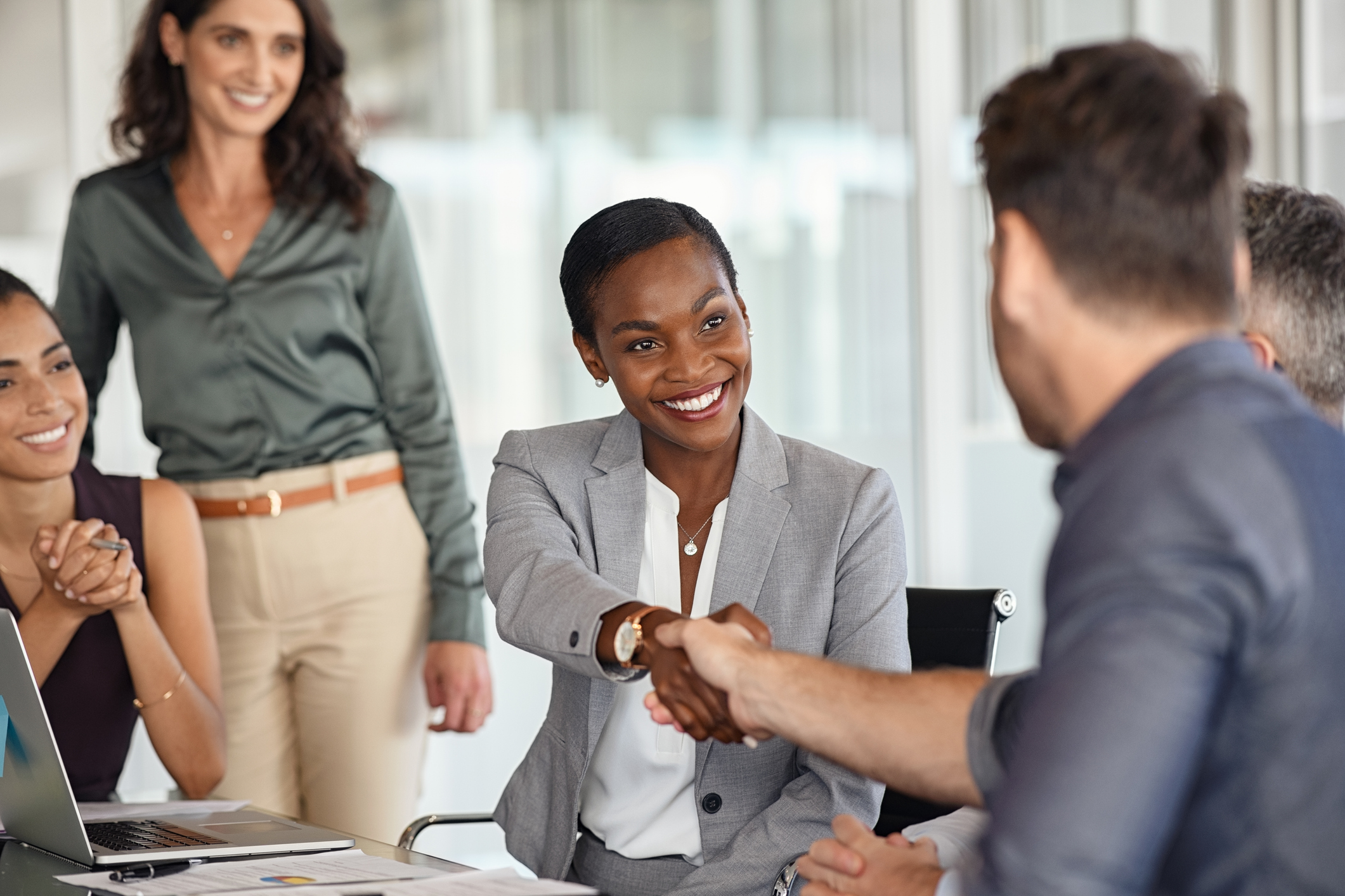 woman shaking hands with man