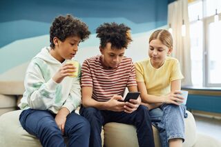 group of people looking at a phone