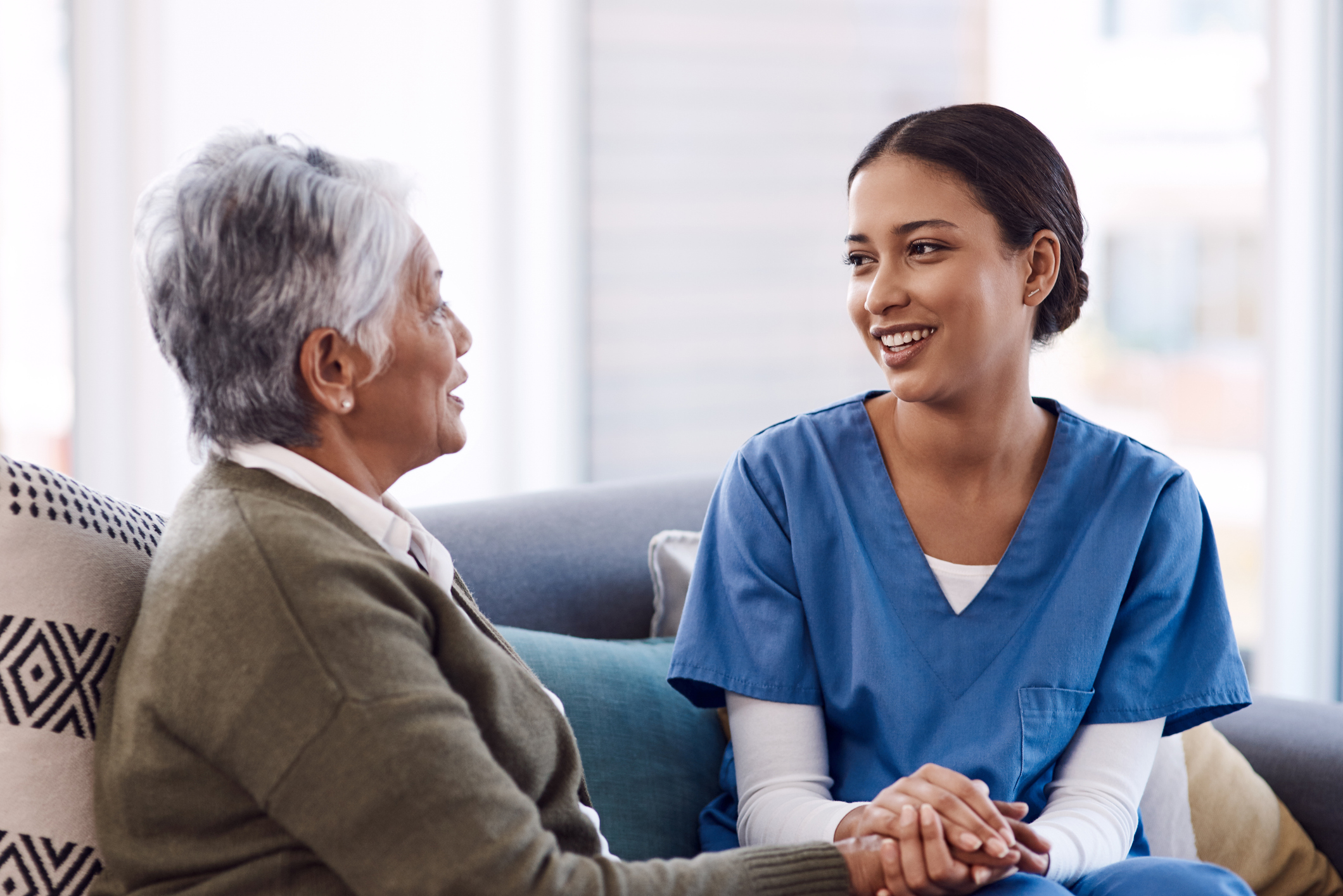 woman holding hands of older woman