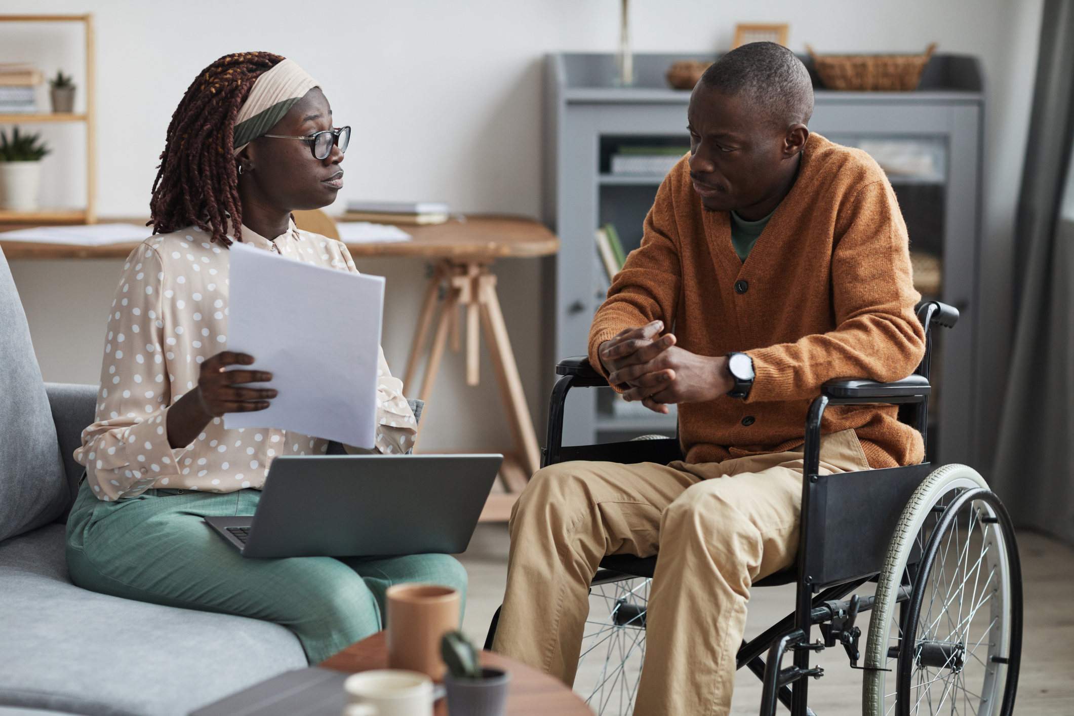 social worker talking to man in wheelchair
