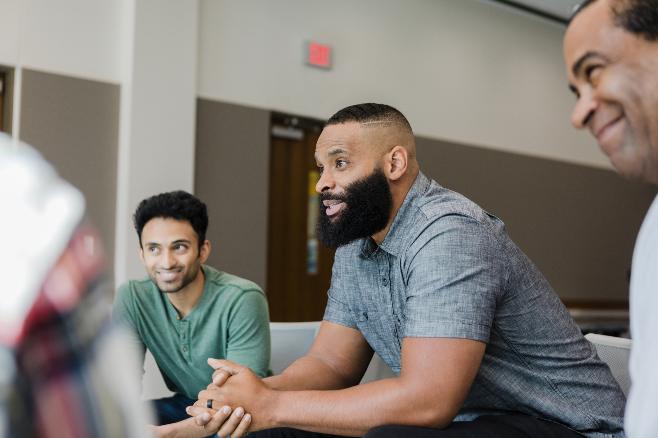 man listening to speaker in group