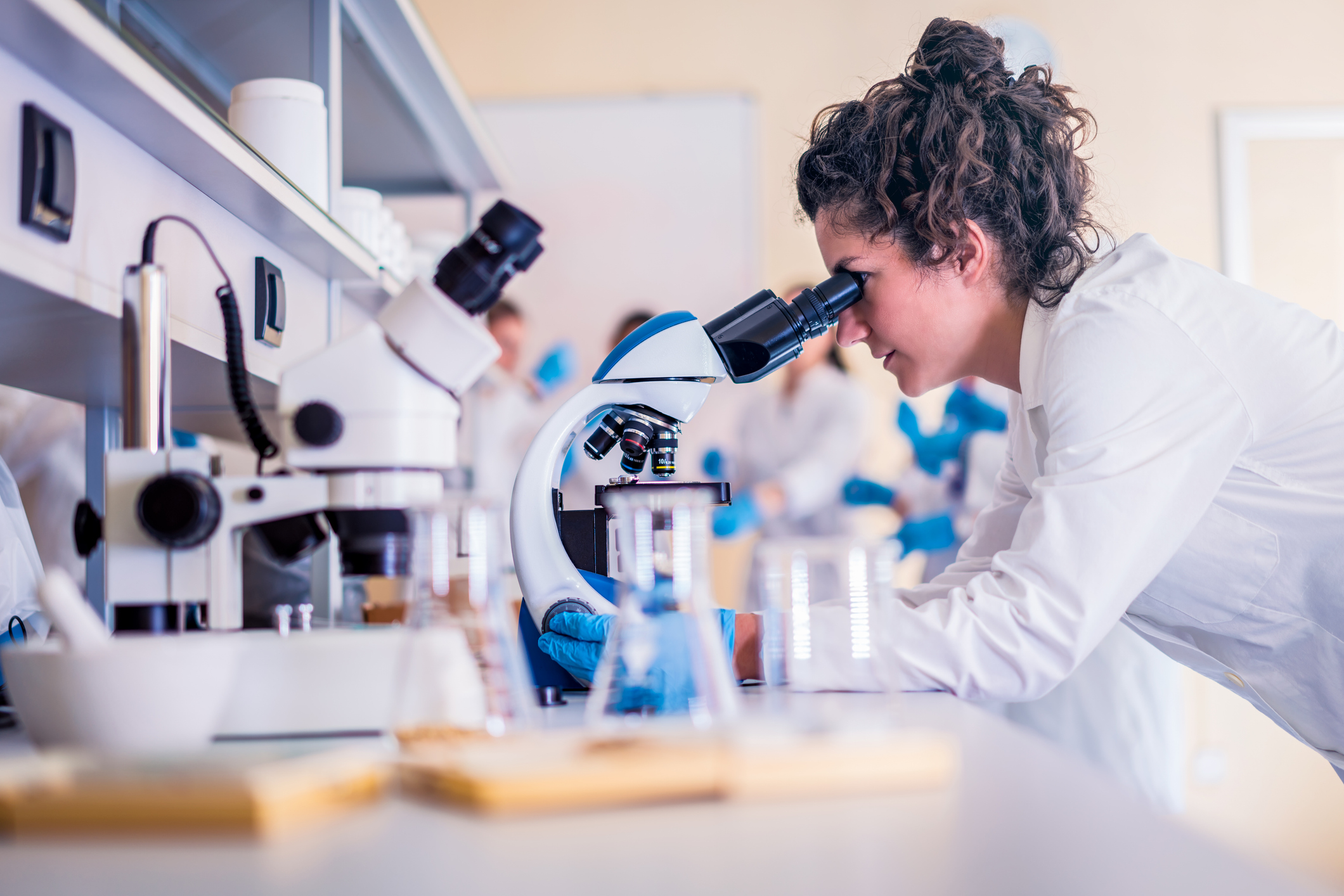 woman looking at a microscope