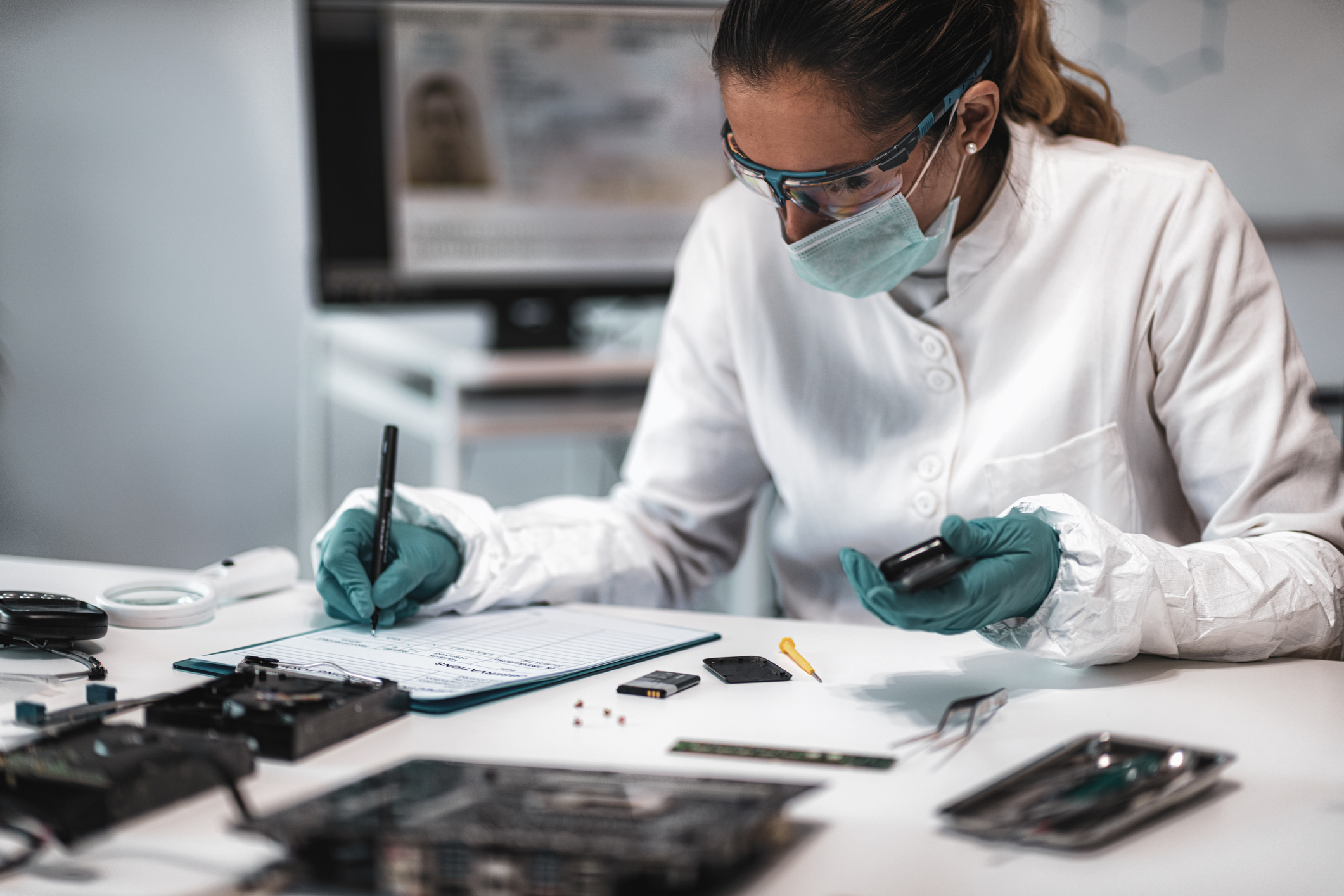 forensic scientist writing on notepad