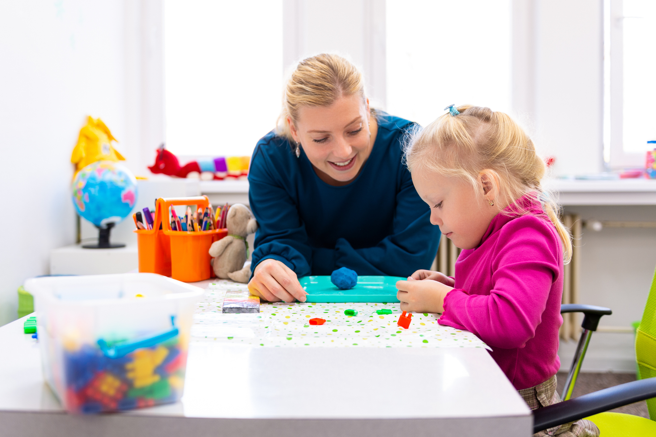 occupational therapist helping a young girl