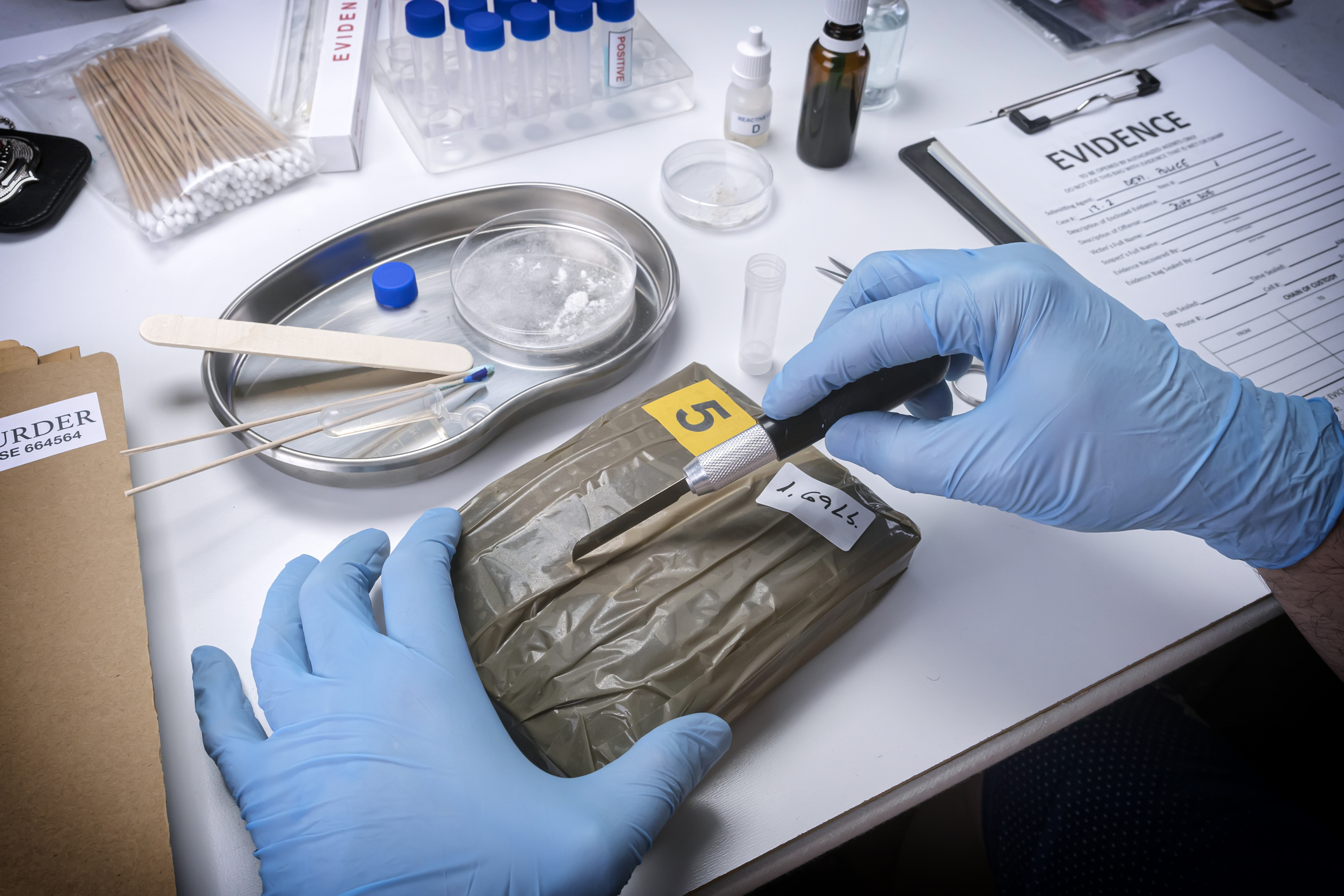 cutting open a bag with evidence