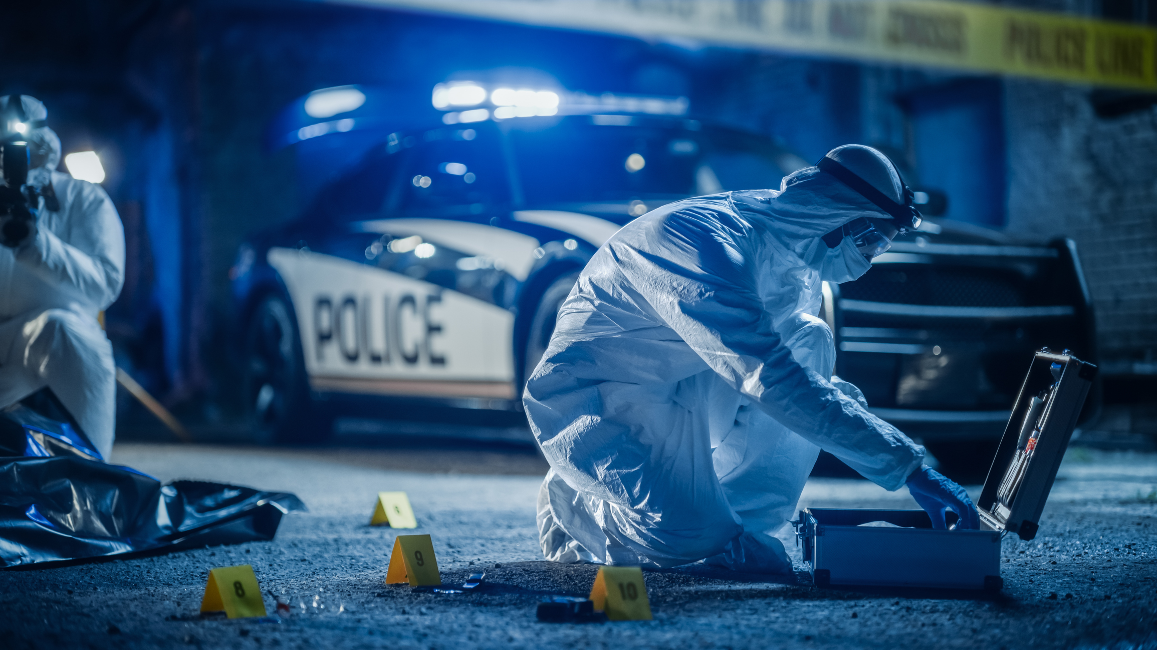 forensics scientist on scene examining evidence