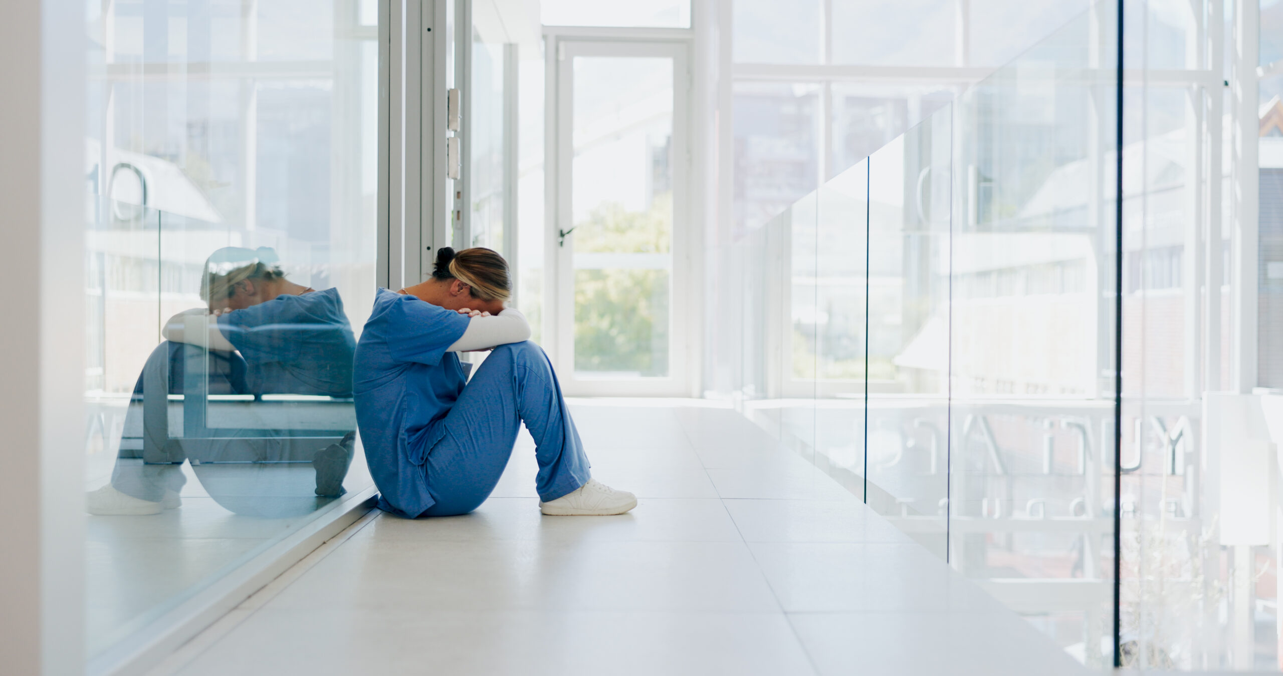 Nurse sitting on ground by wall