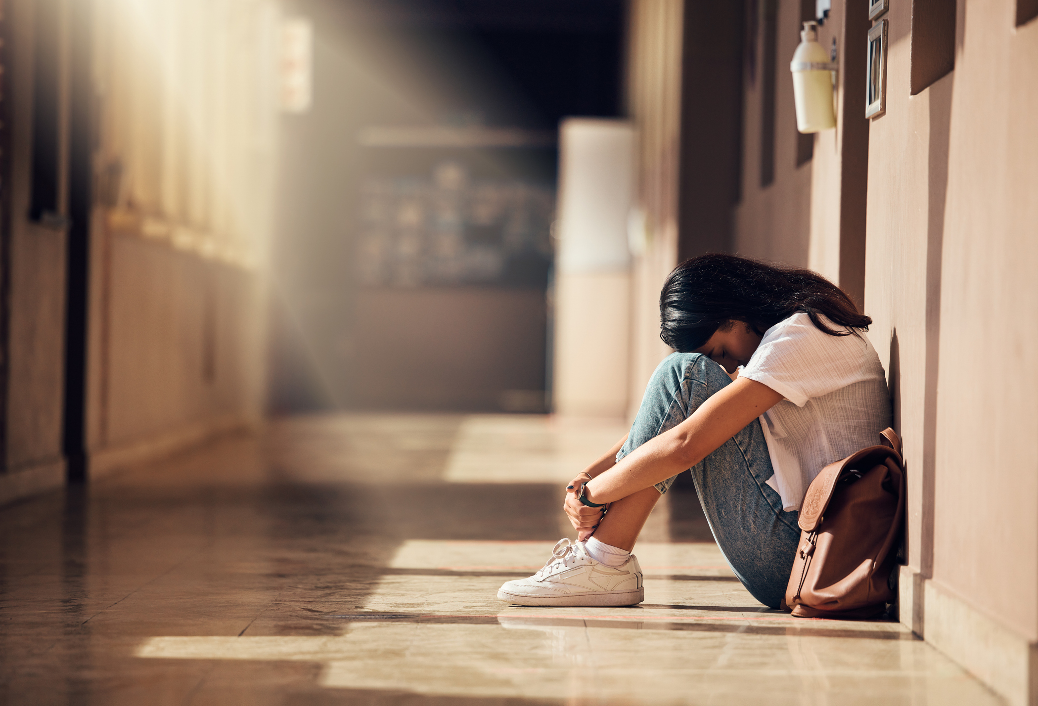 woman in hallway looking depressed