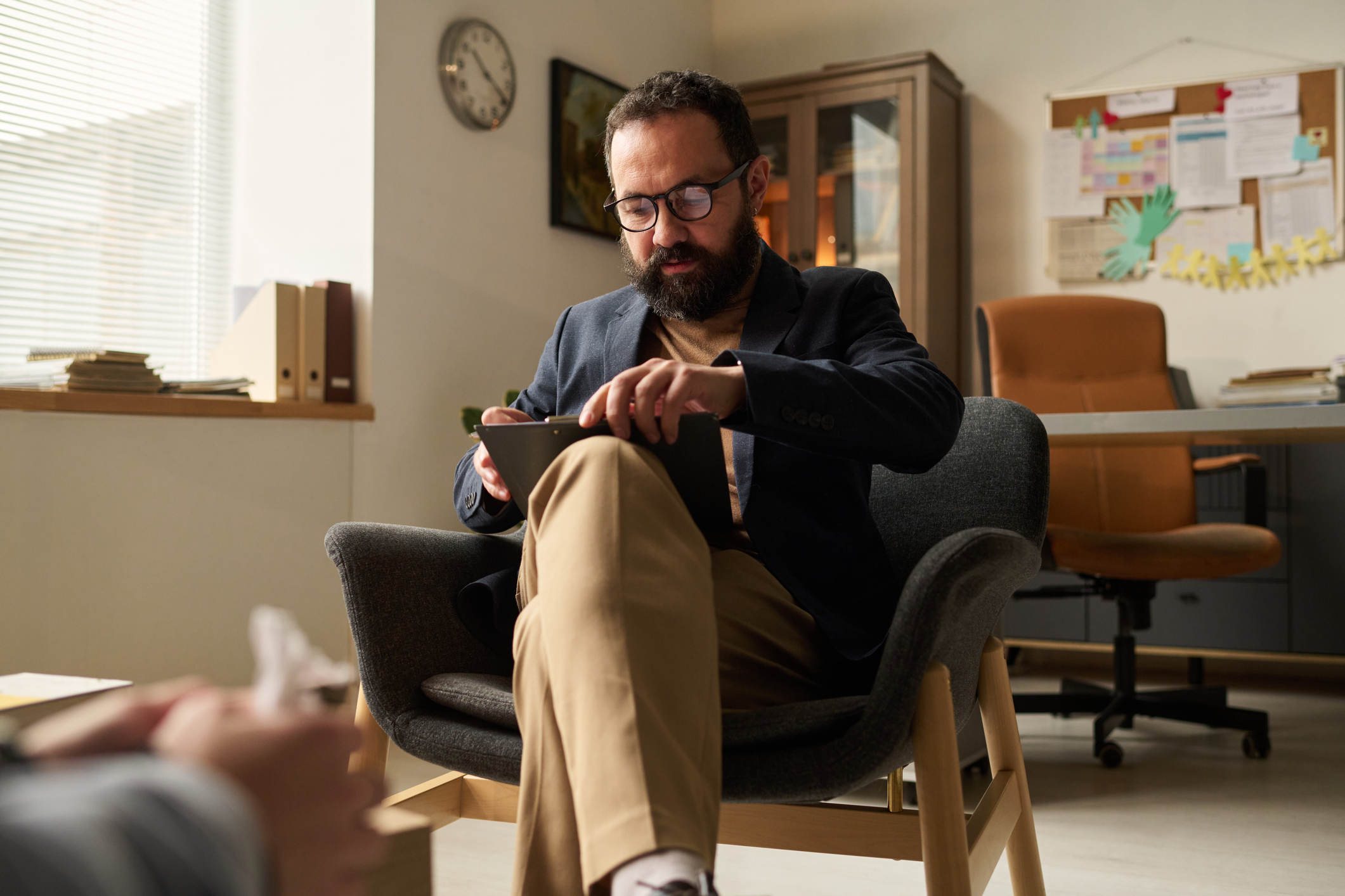 therapist looking at clipboard